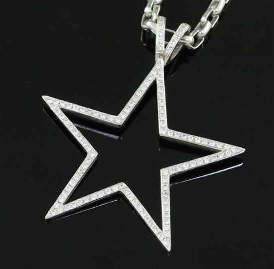 A modern Theo Fennell 18ct white gold and diamond set openwork star pendant on chain.